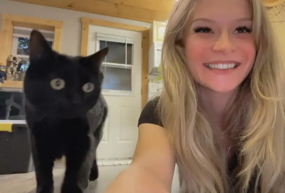 Lexie with a black cat at home — in-home cat sitting in Denver