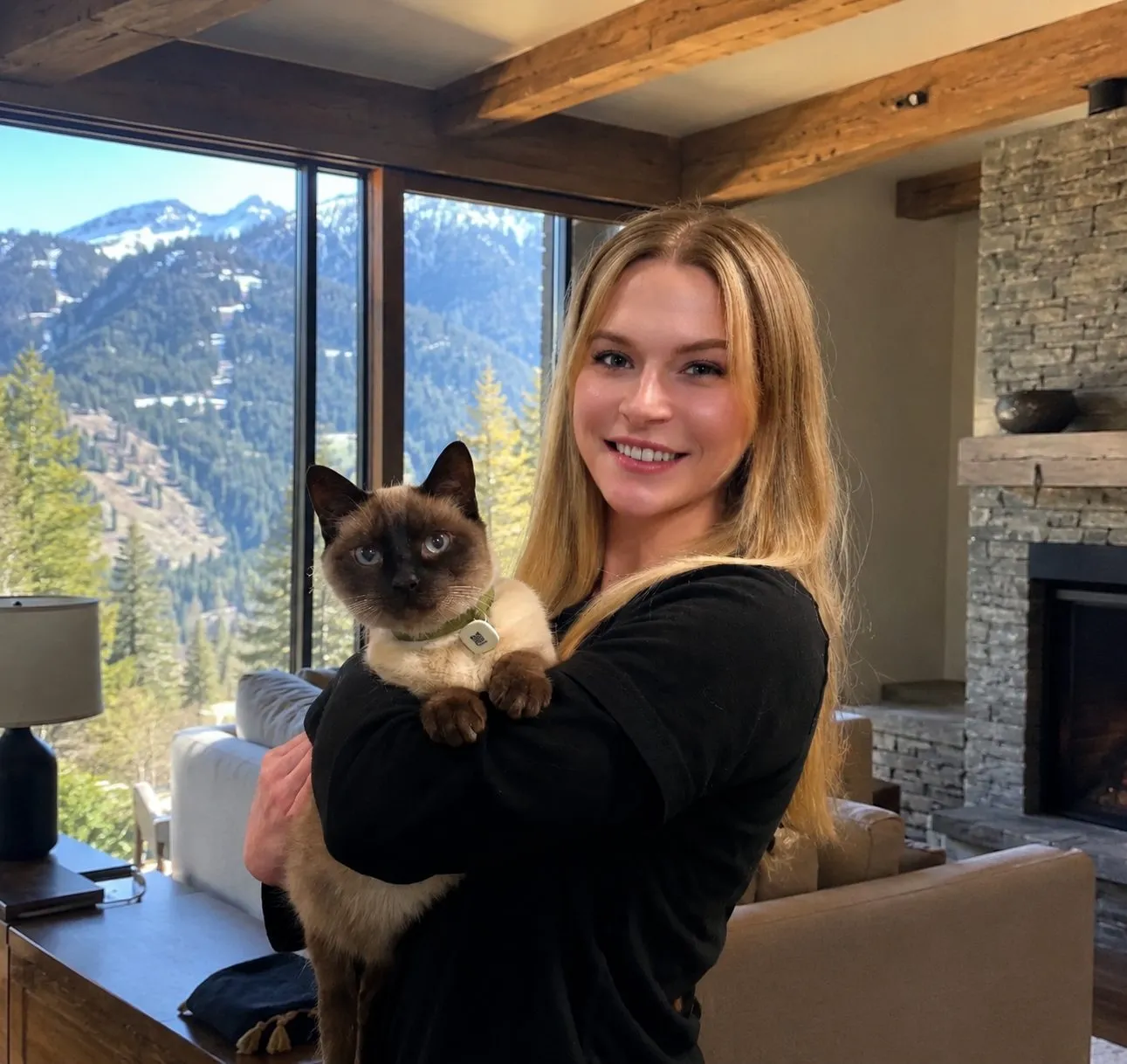 Lexie holding a Siamese cat in a Colorado home — luxury cat sitting Denver