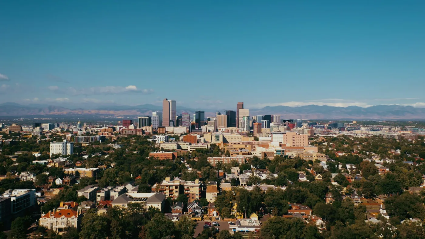 Aerial view of the Denver skyline with the Rocky Mountains in the distance
