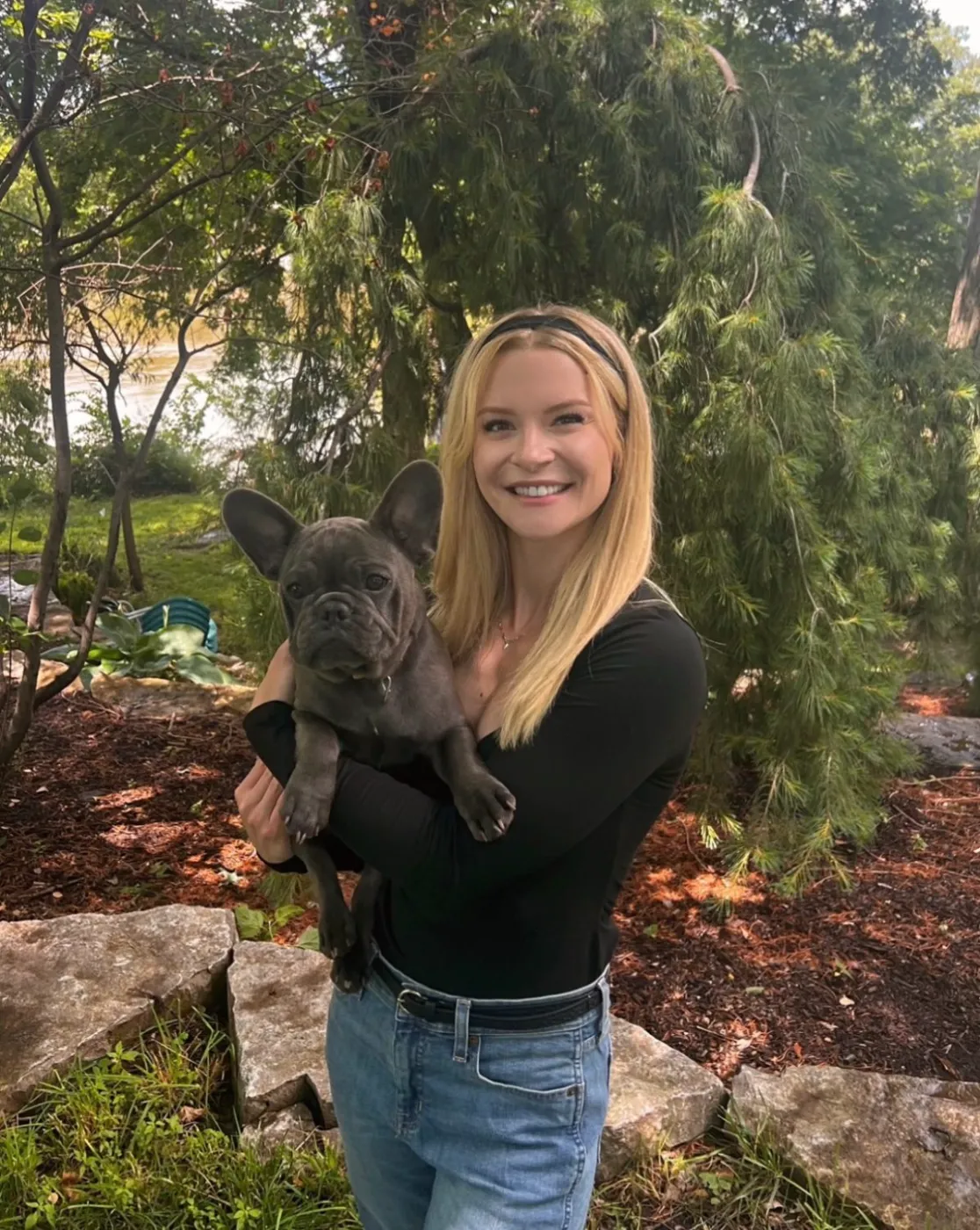 Lexie holding a French bulldog — in-home pet care in Denver