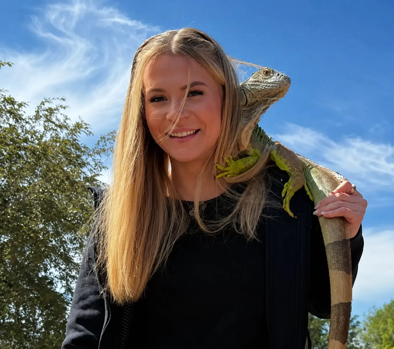 Lexie with an iguana on her shoulder — exotic reptile pet care in Denver