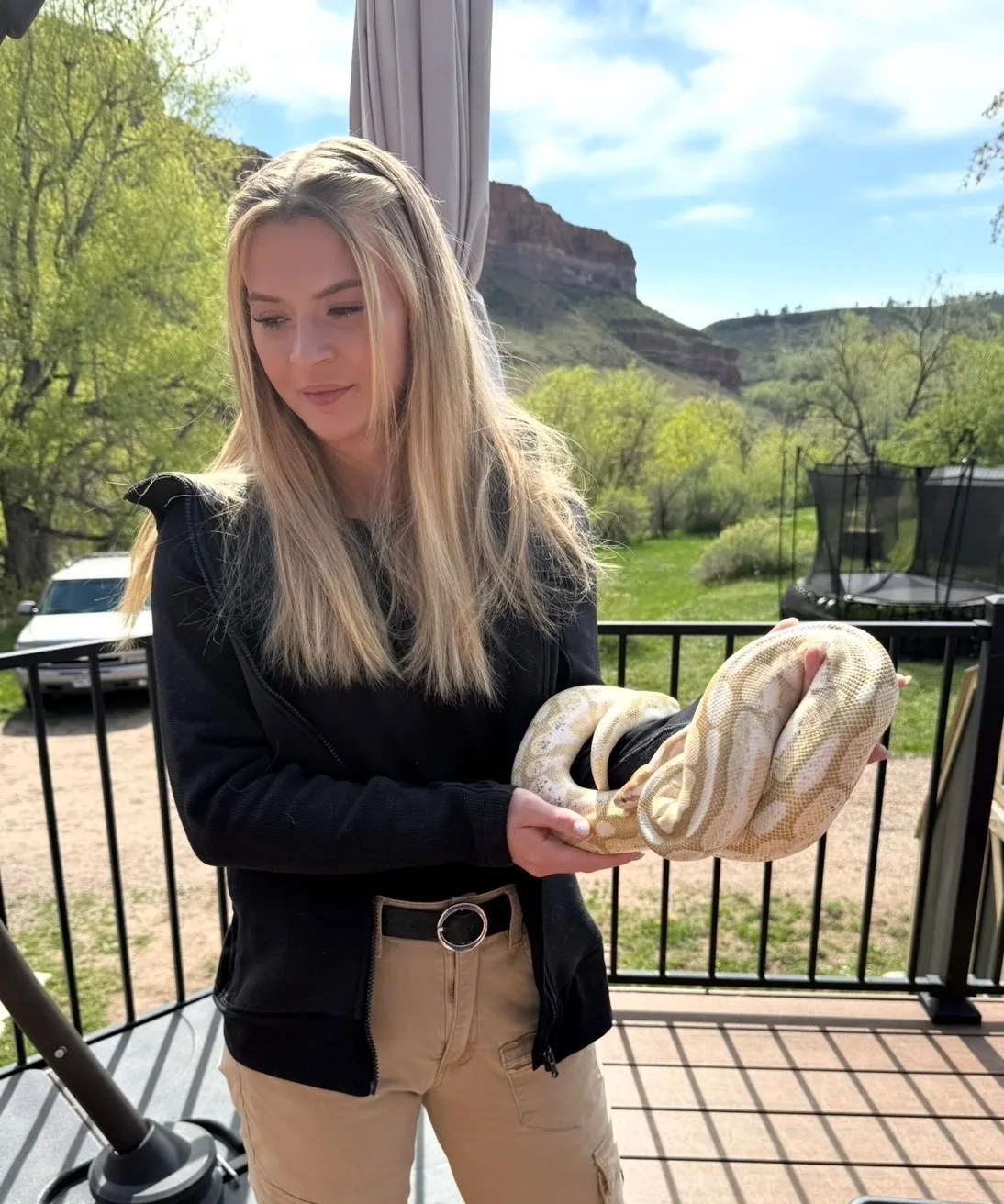 Lexie holding a large python — exotic and reptile pet care by a zoologist near Denver
